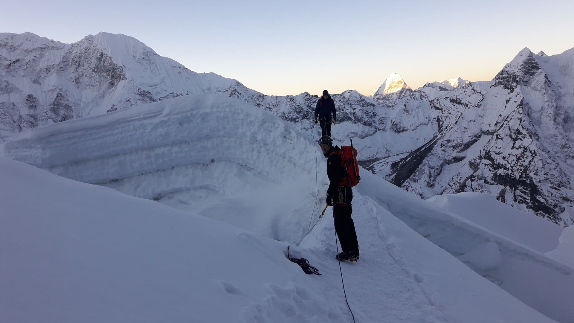 Trekkers are walking up the snowy slope of Island Peak