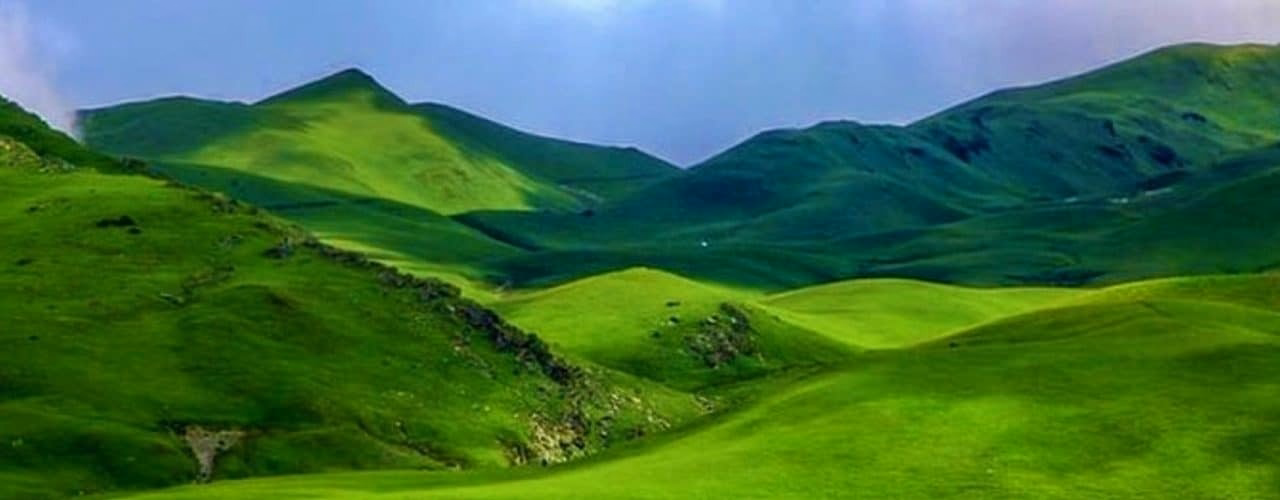 Rolling green meadows of Tribeni Patan in Bajura
