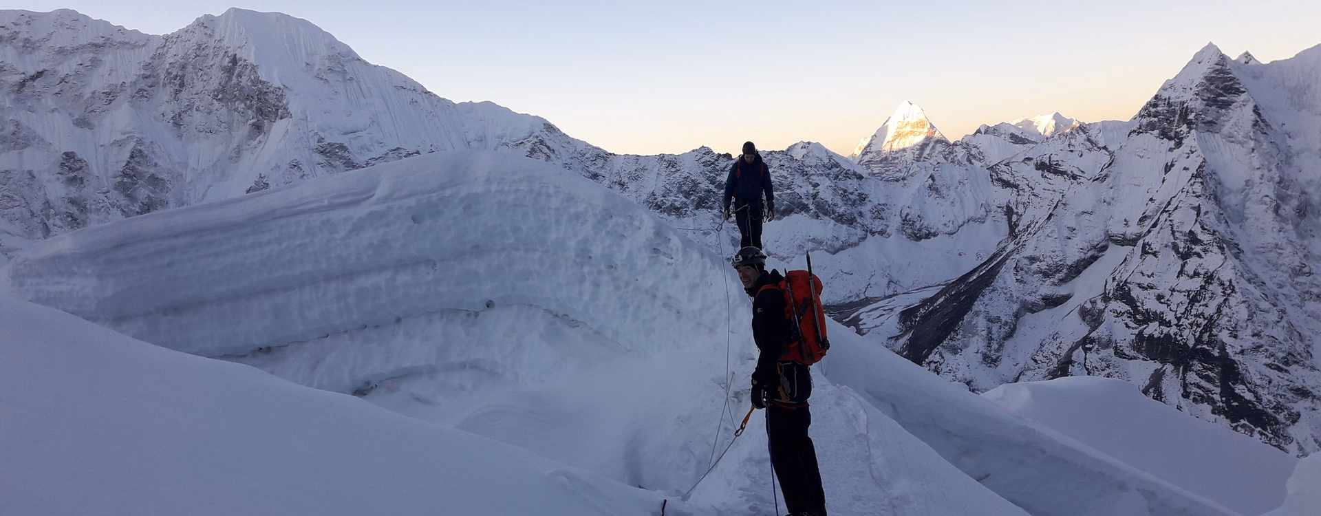 Trekkers walking up the snowy Island Peak