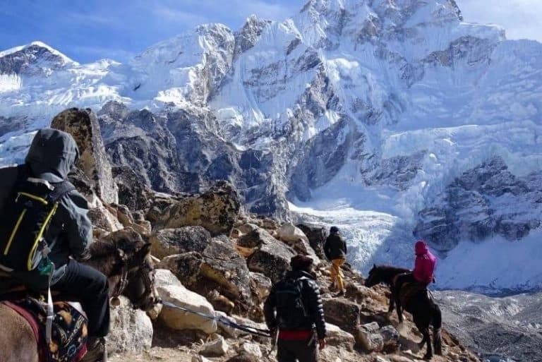 Visitors riding on a horse on the way to Everest Base Camp