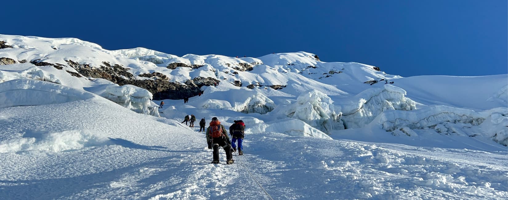 Guided rope climb across the Island Peak glacier