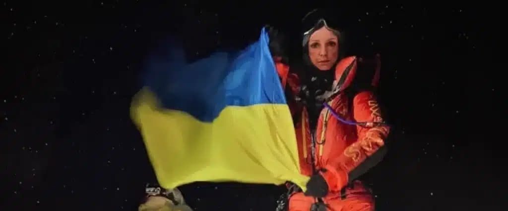 Russian Climber Katya Lipka holds the Ukrainian flag on Mt. Everest