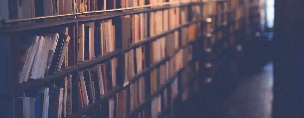 A close-up warm-toned shot of packed bookshelf