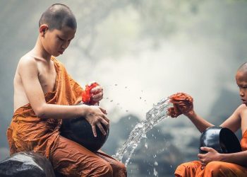 two boys taking bath in river to celebrate Budhha Jayanti