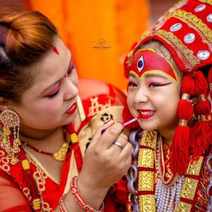 A woman doing a make up of the living female deity