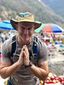 A trekker greeting Namaste during village hike in Nepal
