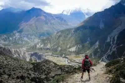 A trekker on short day hike in Manang before attempting to cross the Thorang La Pass in Annapurna Circuit