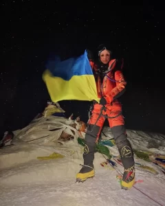Russian Climber Katya Likpa holds the Ukrainian flag on Mt. Everest