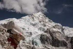 A Local Sherpa carrying a heavy load on the Everest Base Camp route