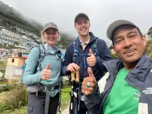 Two male and a female visitor posing for a selfie during Everest Base Camp Trek in Autumn which is one of the best time for traveling to EBC